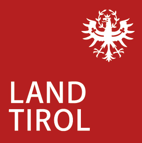 Logo Land Tirol - weißer Schriftzug auf rotem Hintergrund mit Tiroler Adler